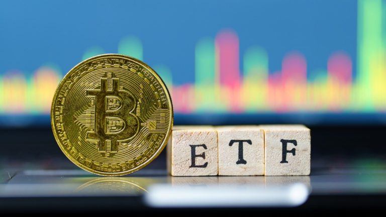 Bitcoin with ETF text on wooden blocks
