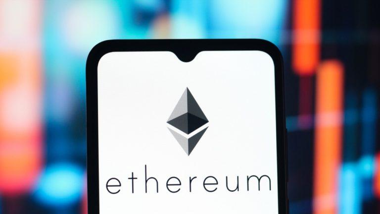 The Ethereum logo is seen displayed on a smartphone screen.
