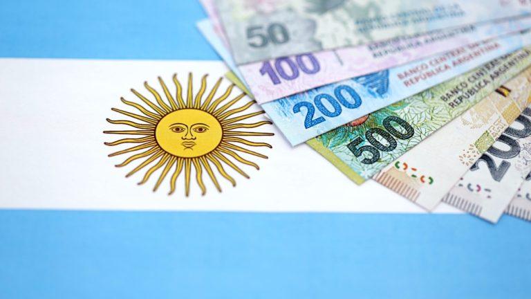 Argentine pesos over Argentina's flag