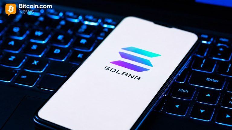 Solana logo on a phone against a laptop background.