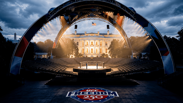 A dramatic nighttime scene shows a UFC octagon cage set up on the lawn directly in front of the illuminated White House.