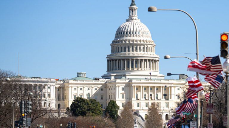 Shot of US Congress from a distance amidst a clear sky backdrop.
