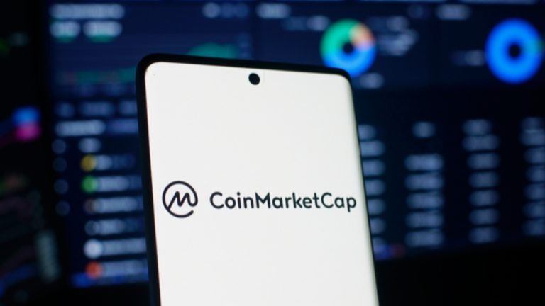 Coinmarketcap on mobile phone with chart in background