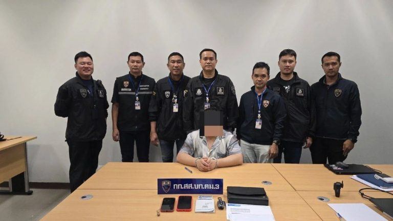 Thai Police With Arrested Suspect